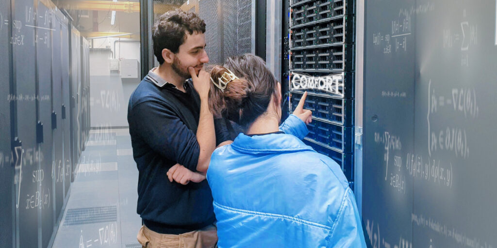 Two people standing in a computer center; COMFORT logo is integrated in the image