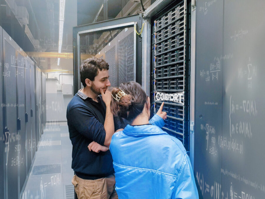 Two people standing in a computer center; COMFORT logo is integrated in the image