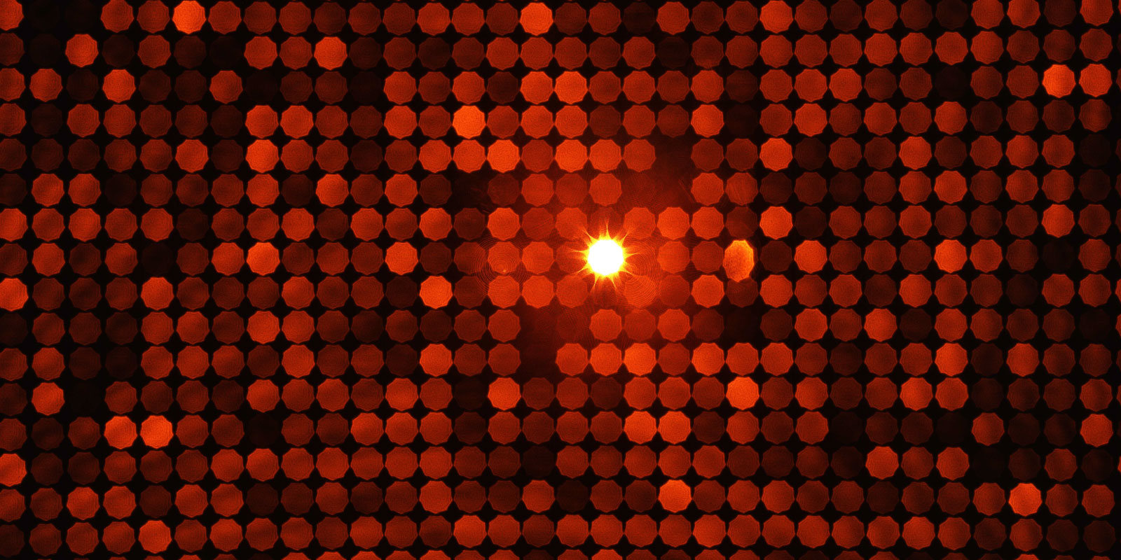 Off-focus image of the diffraction pattern created by a special DOE used for geometric camera calibration. The resulting wallpaper-like image is reminiscent to the disco-look of the 1970s and 80s. Image created by Karsten Stebner, Dennis Dahlke, Tilman Bucher & Ralf Berger (DLR)