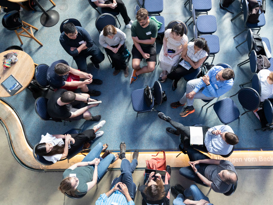 Group of people sitting in a circle; at the Helmholtz Imaging Conference 2024