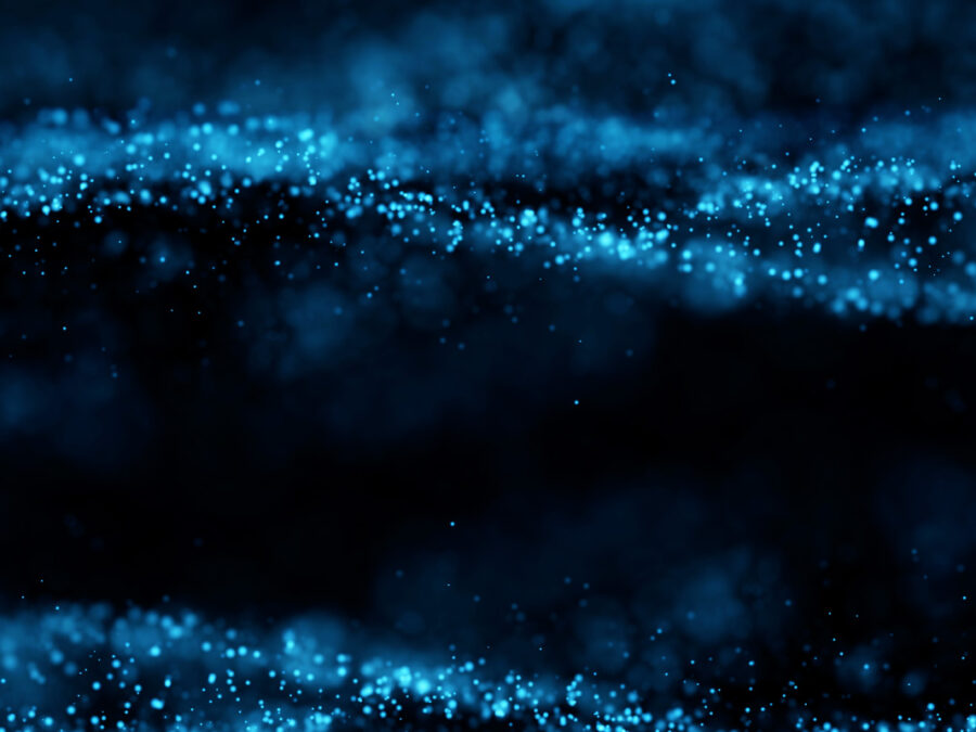 Decorative image showing abstract particles in bluish colors rendering on dark background.